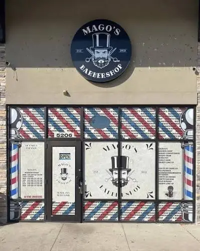 Mago's Barbershop storefront at 5206 E Main St, with the round logo sign and barber-pole striped windows